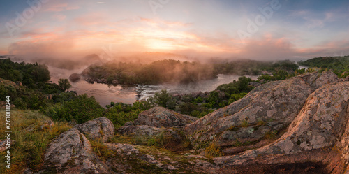 Panorama with bank of river in morning fog