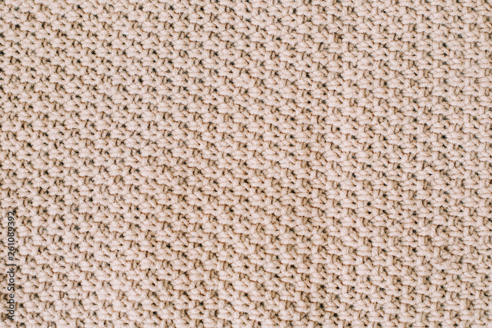Knitted background. Knitting pattern of wool. Knitting. Texture of knitted woolen fabric for wallpaper and an abstract background Knitted background. Knitting pattern of wool. Knitting. Texture of knitted woolen fabric for wallpaper and an abstract background