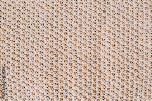 Knitted background. Knitting pattern of wool. Knitting. Texture of knitted woolen fabric for wallpaper and an abstract background