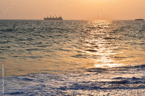 India, Kerala. Beach of the Indian ocean at sunset photo