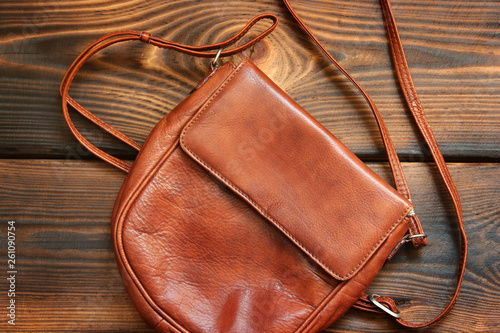 Leather bag on wooden background