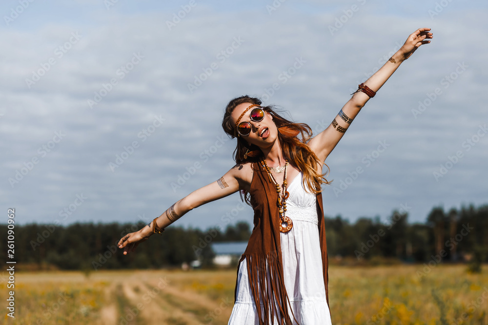 Pretty amazing free red-haired hippie girl dancing outdoors, feathers and  braids in her hair, white dress, vest with fringe, accessories, sunglasses,  tattoo flash, indie, Bohemian, boho style Stock Photo | Adobe Stock