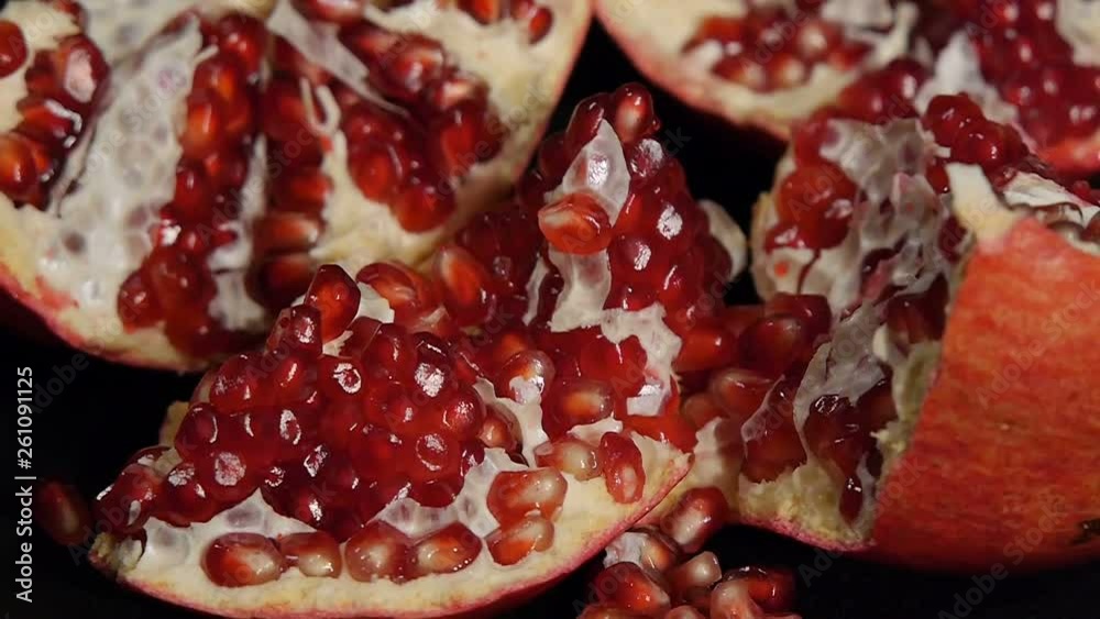 Delicious pomegranate. Portion of fresh made pomegranate. Fresh red pomegranate seeds isolated on a black background. Delicious pomegranate. Portion of fresh made pomegranate. Fresh red pomegranate seeds isolated on a black background.