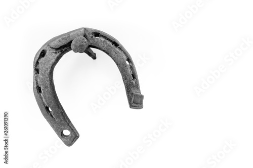 horseshoe hanging on a nail on a white background