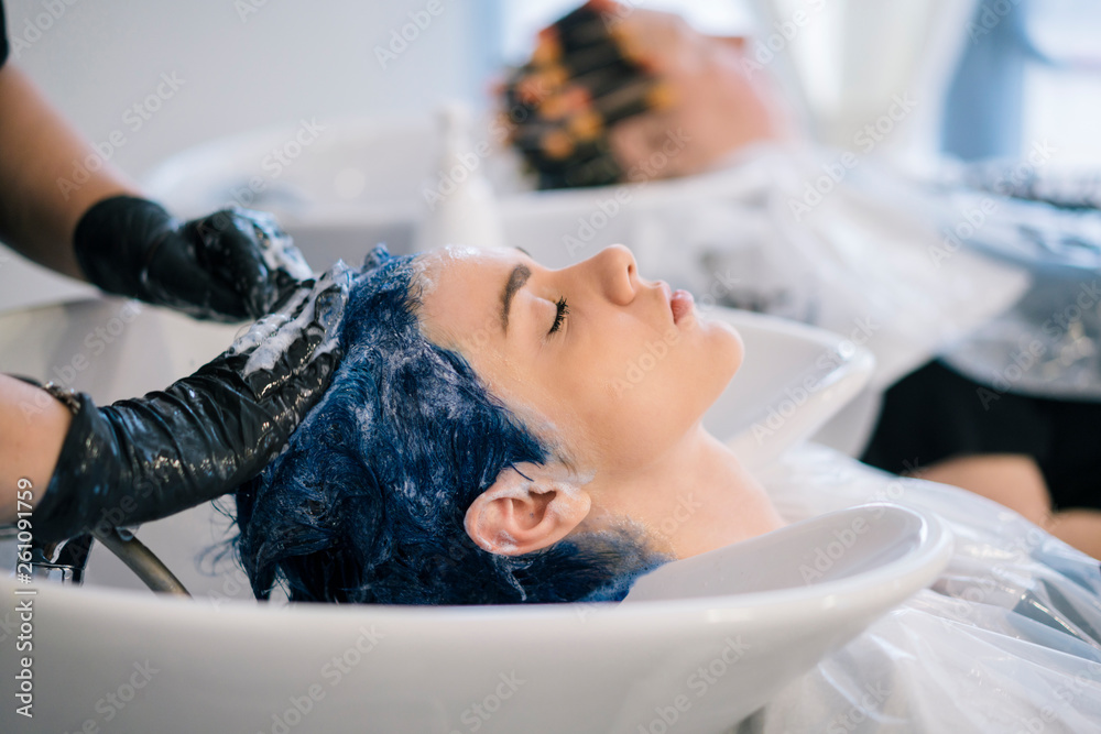 Young Woman dyeing her hair at a Salon Young Woman dyeing her hair at a Salon
