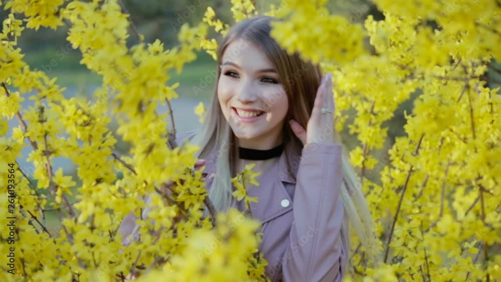 Spring time and happy girl on the landscape of yellow flowers Spring time and happy girl on the landscape of yellow flowers