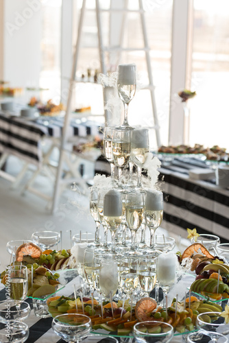 Wedding slide champagne for bride and groom indoors. © Mykola