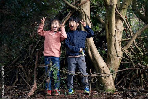 Cute asian little girls activities in the wild in the woods photo