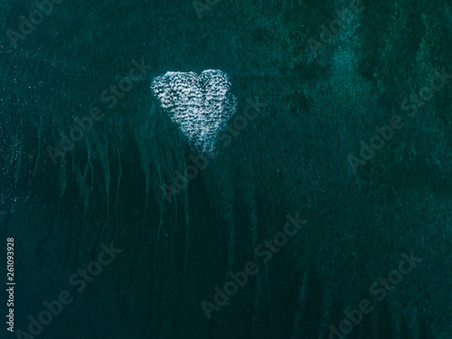 heart shaped wave breaking in the ocean photo