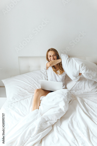 Woman throws a pillow towards the camera