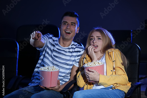 Young couple watching movie...