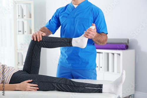 Doctor working with patient in hospital, closeup. Rehabilitation physiotherapy