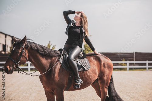 Woman on a horse at rancho. Horse riding, hobby time. Concept of animals and human 