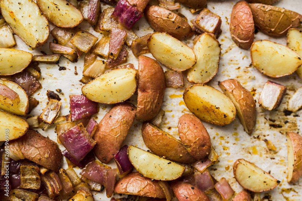 Close up of roasted potatoes and red onions Close up of roasted potatoes and red onions