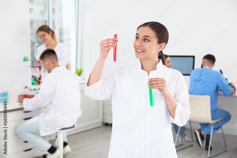 Portrait of medical student with test tubes in modern scientific laboratory Portrait of medical student with test tubes in modern scientific laboratory
