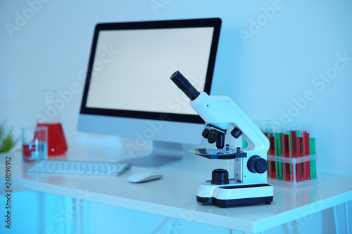 Workplace with computer and microscope for medical student in scientific laboratory