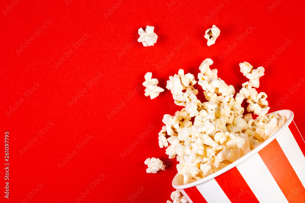 Movie night concept - pop corn, glasses, bright red background Movie night concept - pop corn, glasses, bright red background