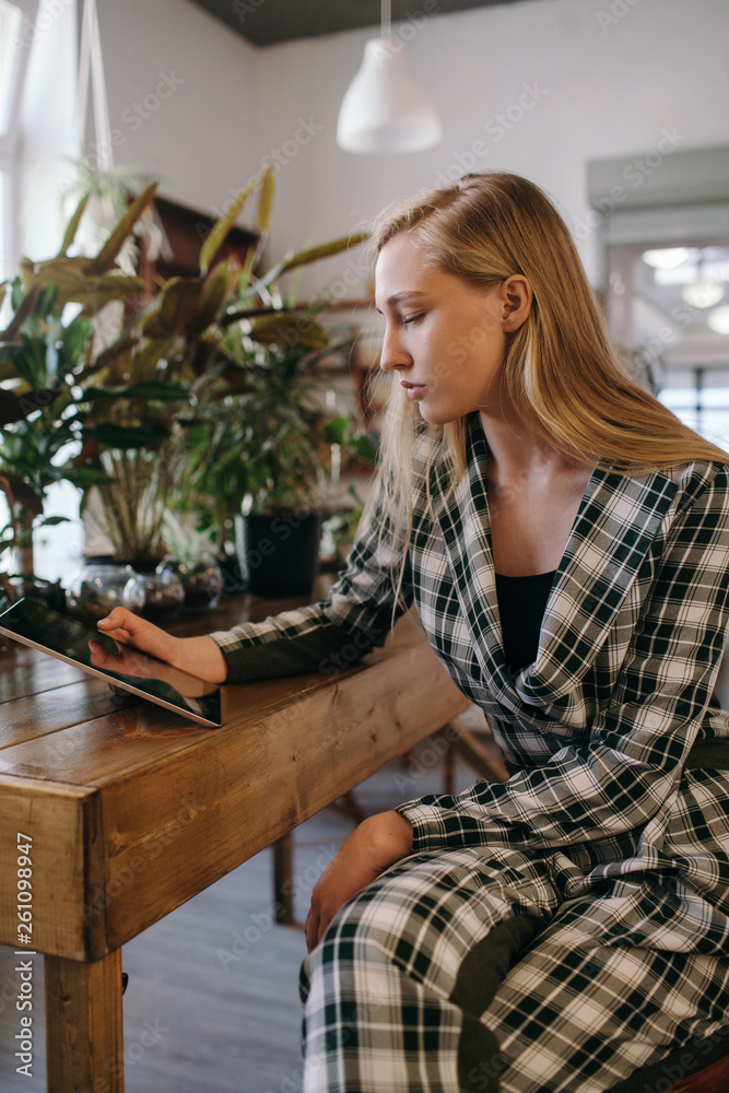 Teenager using her tablet at coffee shop Teenager using her tablet at coffee shop
