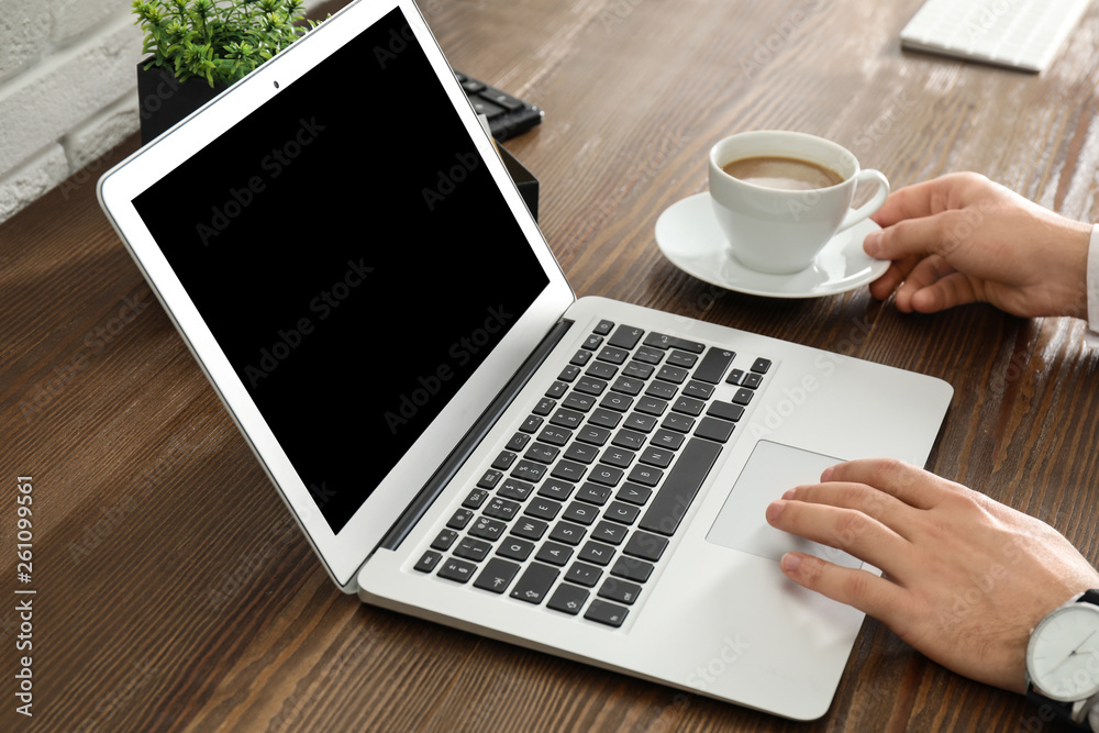 Man using laptop at table, closeup. Space for design Man using laptop at table, closeup. Space for design