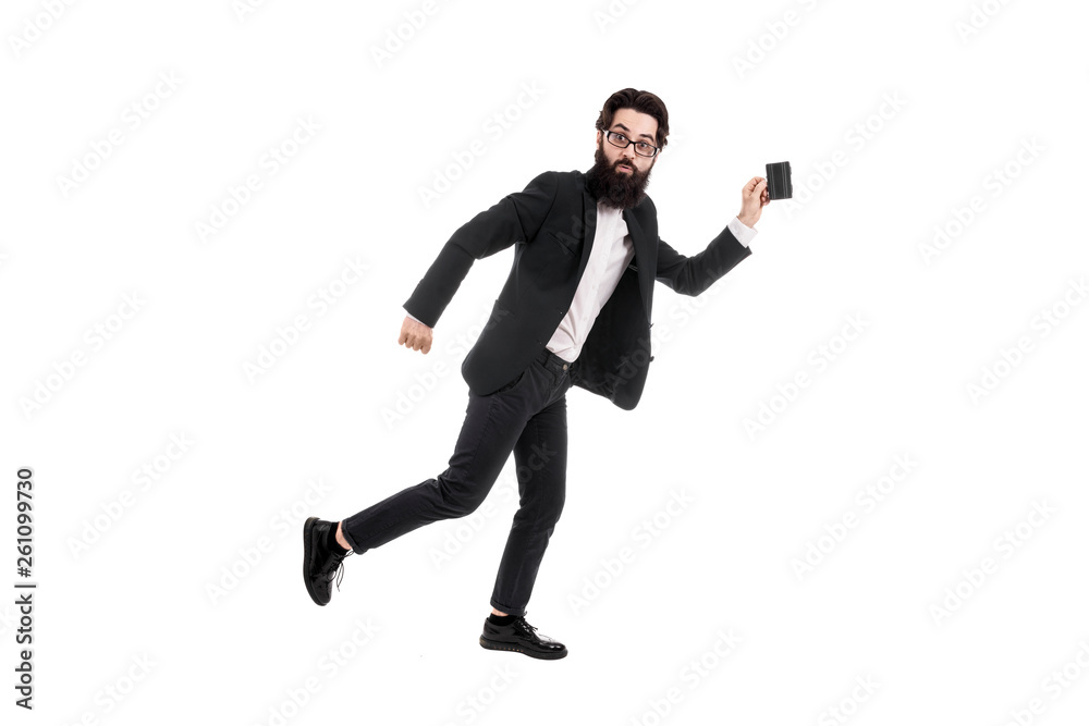 Full length studio portrait of a surprised bearded businessman running with a mini suitcase, isolated on white background Full length studio portrait of a surprised bearded businessman running with a mini suitcase, isolated on white background