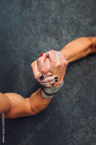 Hands clasped during arm wrestling challenge
