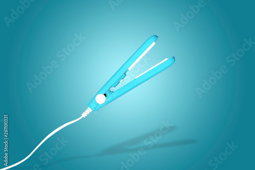levitating hair curling iron over blue background