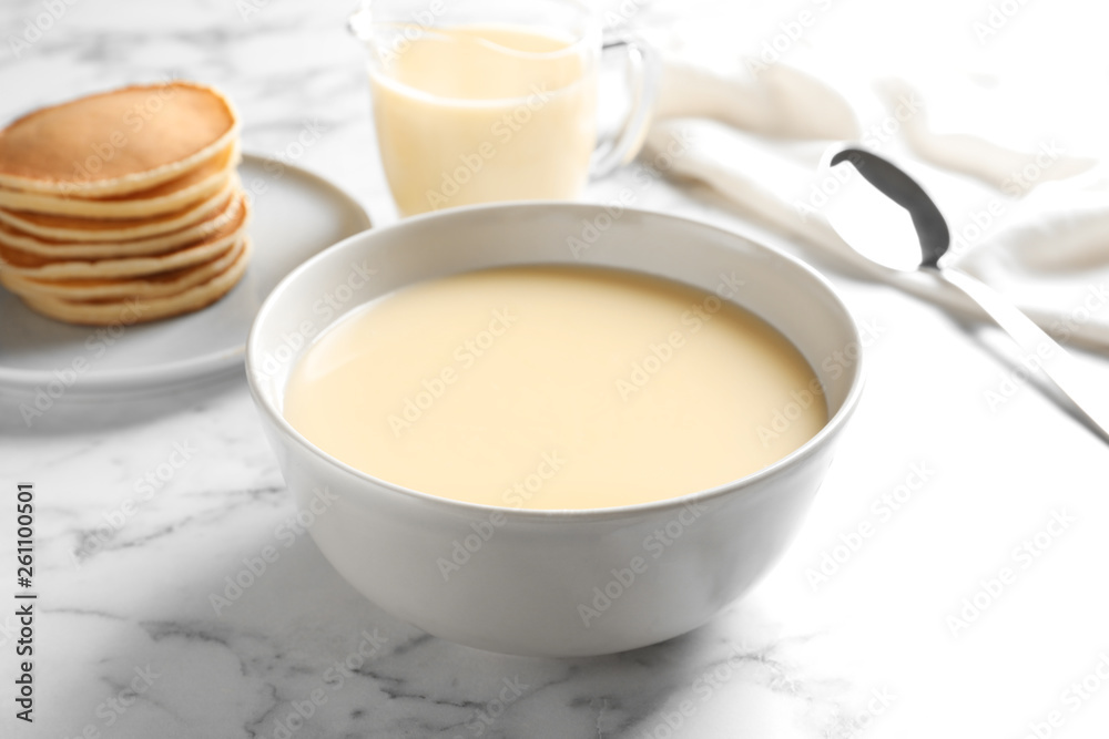 Wunschmotiv: Bowl with condensed milk on marble table. Dairy products #261100501