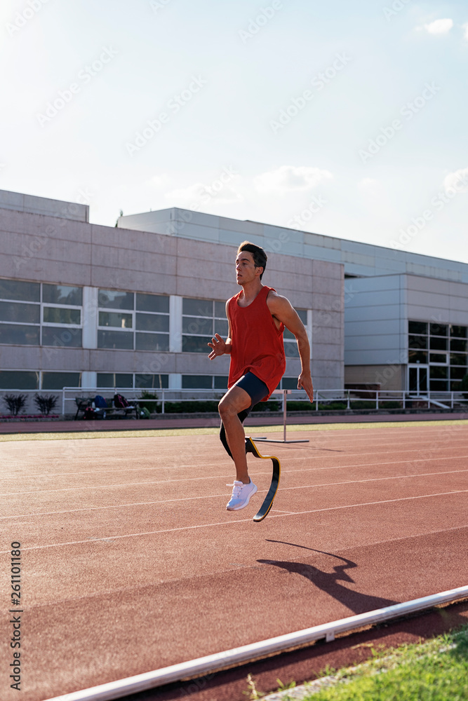 Disabled man athlete training with leg prosthesis Disabled man athlete training with leg prosthesis