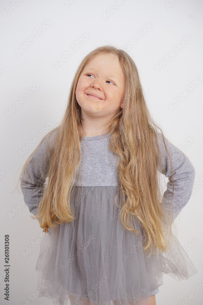 cute caucasian baby girl with long blond hair stands on white background in Studio cute caucasian baby girl with long blond hair stands on white background in Studio