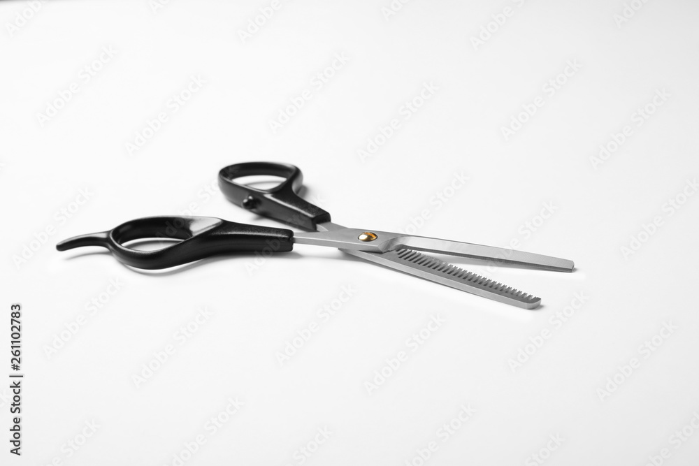 New thinning scissors on white background. Professional hairdresser tool New thinning scissors on white background. Professional hairdresser tool