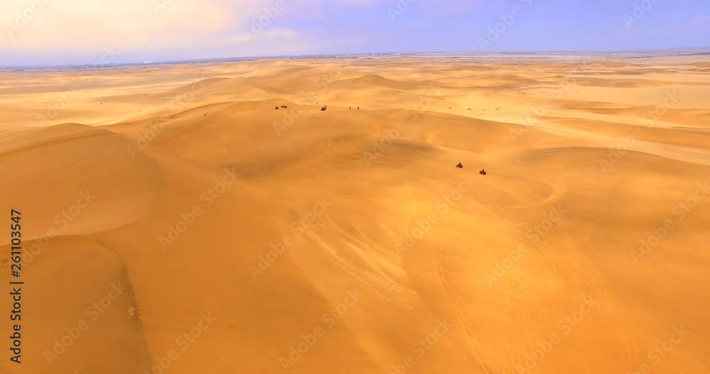 NAMIB-NAUKLUFT NATIONAL PARK, NAMIBIA. Africa’s largest conservation area with mind-blowing desert landscapes. Adventurous tourists riding ATVs under a harsh sun. NAMIB-NAUKLUFT NATIONAL PARK, NAMIBIA. Africa’s largest conservation area with mind-blowing desert landscapes. Adventurous tourists riding ATVs under a harsh sun.