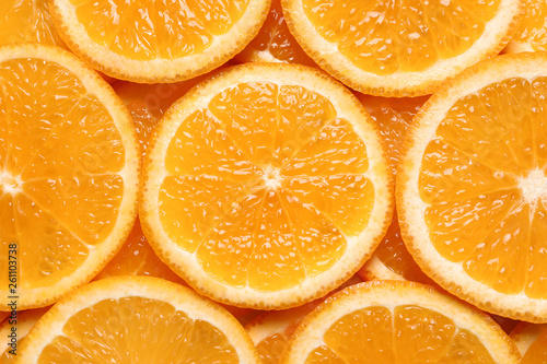 Juicy orange slices as background  top view. Citrus fruit