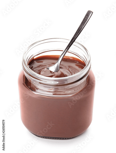 Glass jar with tasty chocolate cream and spoon isolated on white