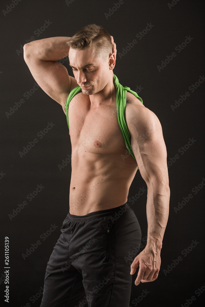 handsome man with muscles on a black background handsome man with muscles on a black background