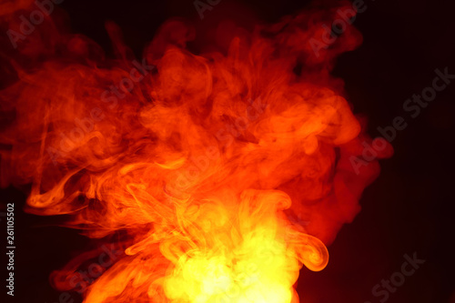 Imitation of bright flashes of orange-red flame. Background of abstract colored smoke.