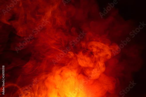 Imitation of bright flashes of orange-red flame. Background of abstract colored smoke. © Mikhail