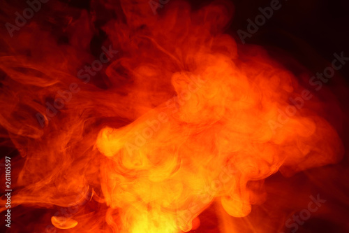 Imitation of bright flashes of orange-red flame. Background of abstract colored smoke.