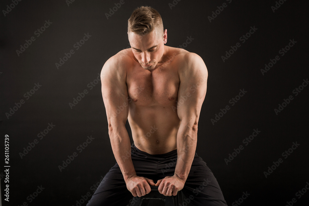 handsome man with muscles on a black background