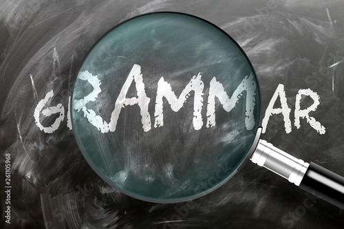 Learn, study and inspect grammar - pictured as a magnifying glass enlarging word grammar, symbolizes researching, exploring and analyzing meaning of grammar, 3d illustration photo