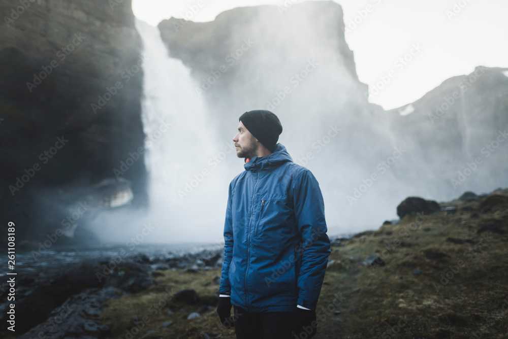 Hiker by Haifoss waterfall in Iceland Hiker by Haifoss waterfall in Iceland