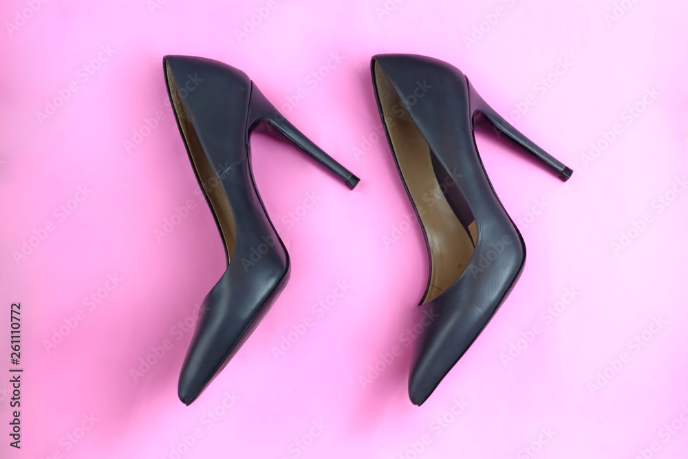 Trendy glamour fancy black leather classic pair of elegant high heeled shoes on pink background Trendy glamour fancy black leather classic pair of elegant high heeled shoes on pink background