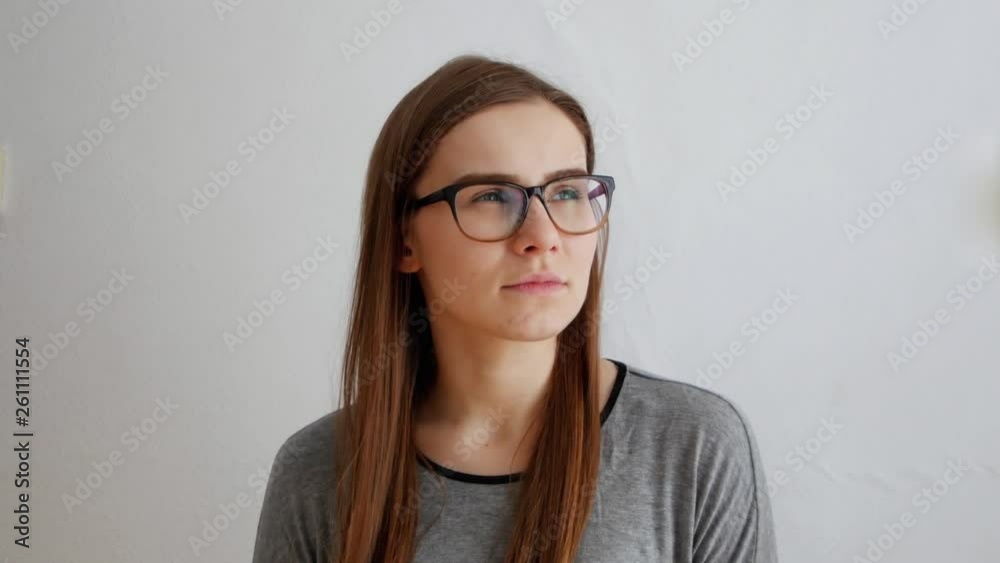 Sad thoughtful young beautiful female istanding in hesitation on white background Sad thoughtful young beautiful female istanding in hesitation on white background