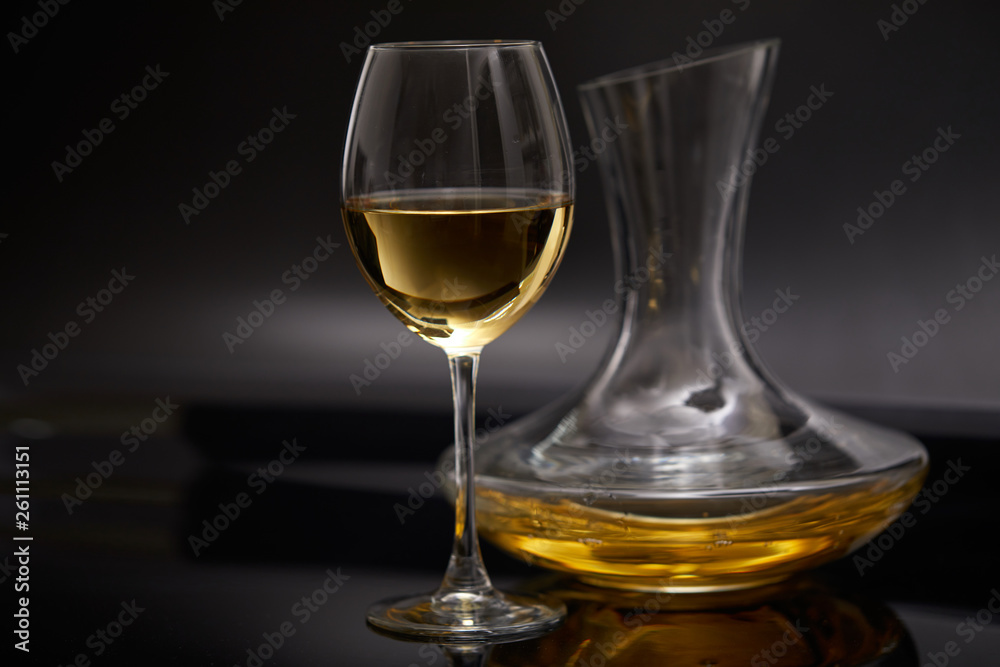 A glass full of wine and wine decanters A glass full of wine and wine decanters