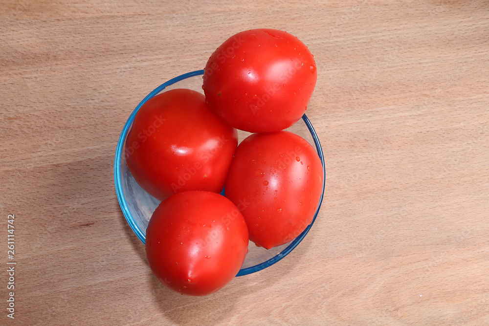 Tomatoes on a wooden background, tasty and healthy food, diet food Tomatoes on a wooden background, tasty and healthy food, diet food