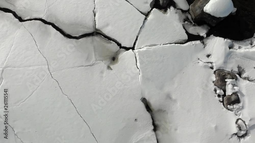 Aerial, top down, drone shot, over ice blocks, on a snowy river, on a cloudy, winter day, at Pontarikoski rapids, near Joensuu, North Karelia, Finland photo