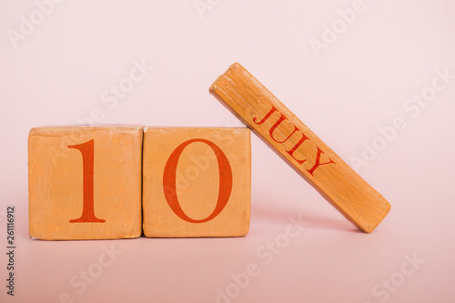 july 10th. Day 10 of month, handmade wood calendar  on modern color background. summer month, day of the year concept photo