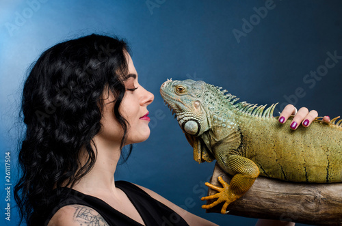 pretty woman and green iguana in studio