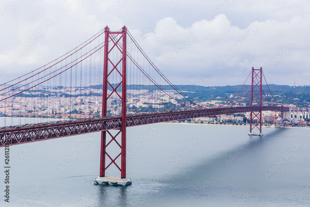 Obraz premium Ponte 25 de Abril Bridge in Lisbon, Portugal. Connects the cities of Lisbon and Almada crossing the Tagus River. View from Almada with Lisbon across