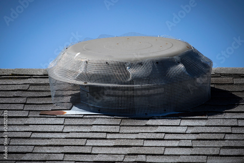 Obraz na plátně Wire mesh installed on roof top attic fan to prevent rodent entry to home/attic