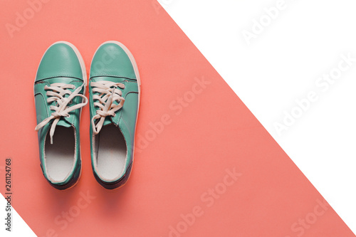 BLUE sneakers on a light pink background. FASHION COLOR 2019 PANTON. Women's boots. stylish BLUE sneakers